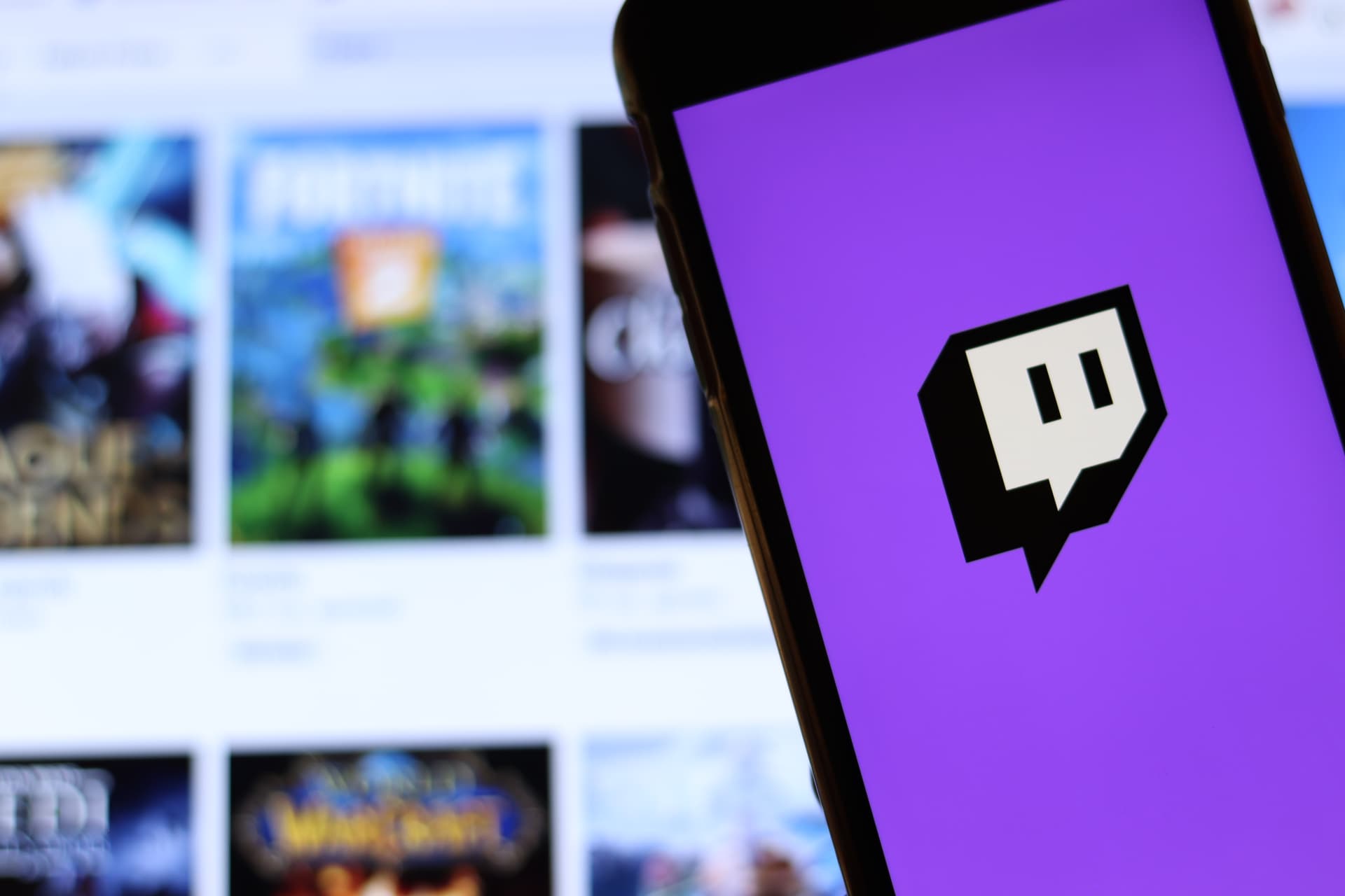 Los Angeles, California, USA - 21 November 2019: Twitch.tv logo on phone screen with icon on laptop on blurry background, Illustrative Editorial.
